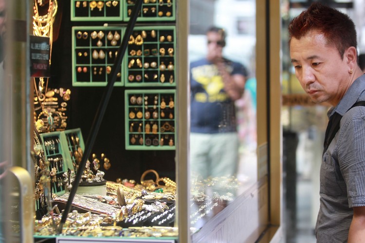 A man looks in the window of a store in the Diamond District July 29 in New York in this file photo. During the third quarter, demand for gold has increased by 6 percent over the same period in 2010. (Photo TIMOTHY A. CLARY/AFP/Getty Images)