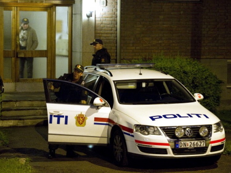 Police guard the entrance of the address of the man identified by Norwegian police as the gunman and alleged bomber. (Odd Andersen/AFP/Getty Images)