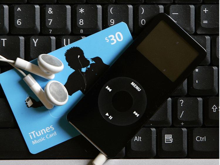 CD NO MORE: Buy tunes with your ITunes music card download to your computer, and listen with your iPod Nano. No packaging, no shipping, no waste.    (Robert Sullivan/AFP/Getty Images)