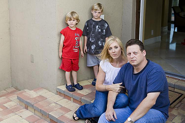 NIGHTMARE HOME: (R-L) John Willis, wife Lori, and their children, Brannon, 5, and Alex, 3 Â½, outside their home in Florida. Brannon recently had IV antibiotic treatment and surgery. The family believes their health problems are caused by tainted Chinese drywall. (Yelena Bleiman)