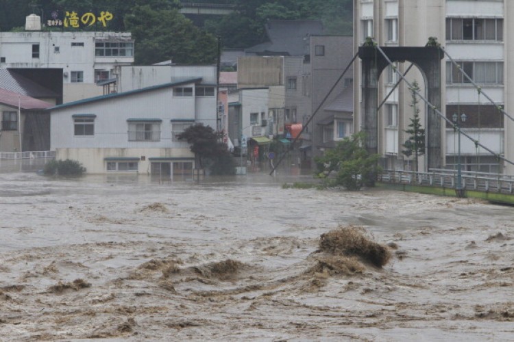 Muddy stream from the Tadamigawa River overflow after heavy rain in Yanaizu, Fukushima Prefecture, on July 30, 2011.  (Jiji Press/AFP/Getty Images)
