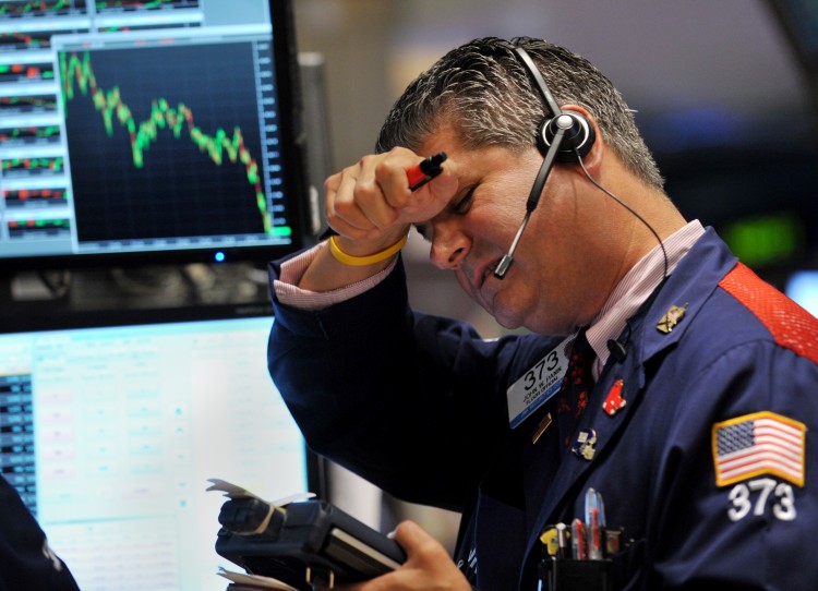 FREEFALL: A trader works on the floor of the New York Stock Exchange, August 4. The Dow Jones Industrial Average plunged 512.76 points, or 4.3 percent, Thursday, its worst one-day drop in more than two years. (Stand Honda/Getty Images)