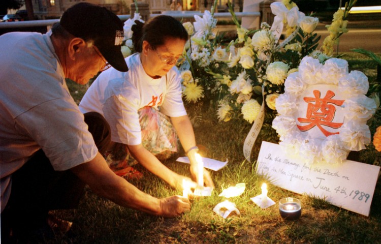 Demonstrators Light Up Candles During A Candlelight Vigil on June 4, 1999
