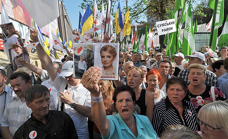 Supporters of Ukraine's former prime minister Yulia Tymoshenko cheer and shout slogans in front of the Pechersk district court on August 8, in Kiev as Tymoshenko's return to trial today on charges of abuse of power over gas deals she signed with Russia in 2009. (GENYA SAVILOV/AFP/Getty Images)
