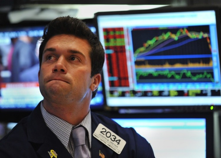 STOCKSLIDE: A trader watches helplessly on the floor of the New York Stock Exchange during afternoon trading, August 8. The Dow tumbled more than 600 points after Standard and Poor's downgraded the U.S. credit rating to AA+.  (Stand Honda/Getty Images)