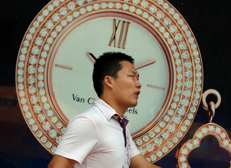 A man walks by a luxury watch store in the Wangfujing shopping street of Beijing on August 9. Luxury watches, far too expensive for Communist Party officials pay scales, can be a sure sign of corruption, writes a former CEO of a joint venture firm. (Mark Ralston/Getty Images)