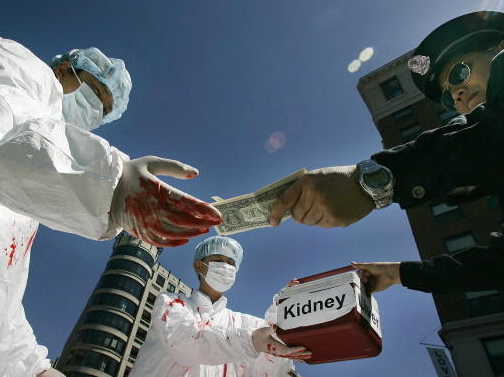 Falun Gong demonstrators dramatize an illegal act of paying for human organs