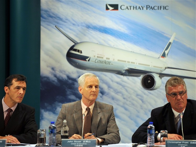 Cathay Pacific executives answer questions during a press conference regarding the airline's half-year results in Hong Kong, Aug. 10. Industrywide, air travel growth is slowing and air cargo volume is plummeting. (Laurent Fievet/AFP/Getty Images)