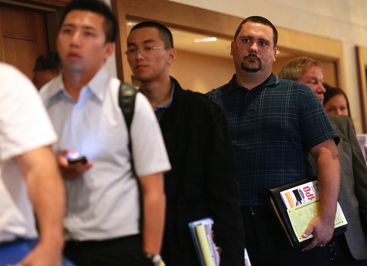 JOB SEEKERS: Job seekers read pamphlets as they wait in line to enter the HIREvent job fair in San Jose, Calif., Aug. 10. The national unemployment rate sits at 9.1 percent. (Justin Sullivan/Getty Images)