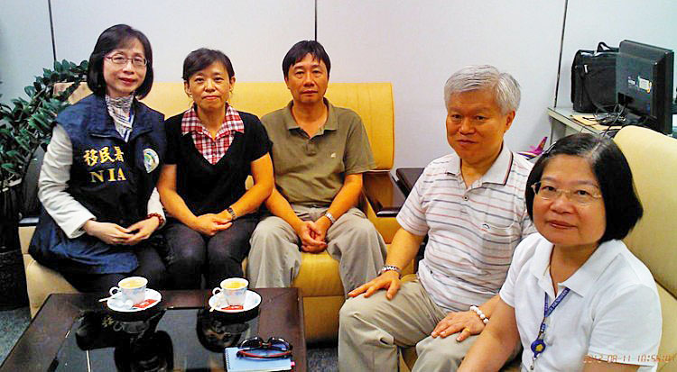 Chung Ting-pang (third from left) sitting with family after his release