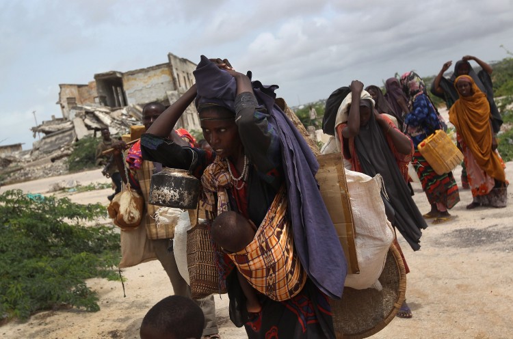 An extended family arrives at a makeshift camp for Somalis displaced by drought and famine on August 13, 2011 in Mogadishu, Somalia. (John Moore/Getty Images)