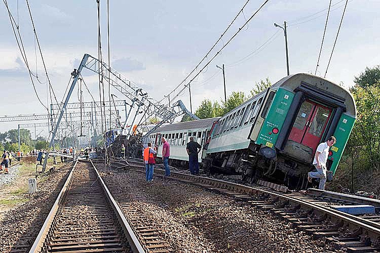 A picture taken on August 12, 2011 shows people walking near damaged and derailed carriages of an inter-city train between Warsaw and Katowice, in Baby, near Piotrkow Trybunalski, central Poland. Four passengers were killed and at least 30 injured in the  (Grzegorz Michalowski/AFP/Getty Images)