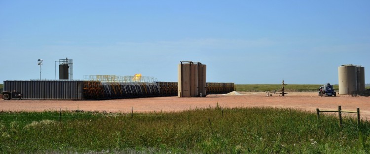 Natural gas is burned off next to water reservoirs used for hydrofracking at an oil well site near Tioga, N.D., on Aug. 23. New York's Department of Environmental Conservation has studied hydrofracking in other states prior to issuing its recommendations. (Karen Bleier/AFP/Getty Images)