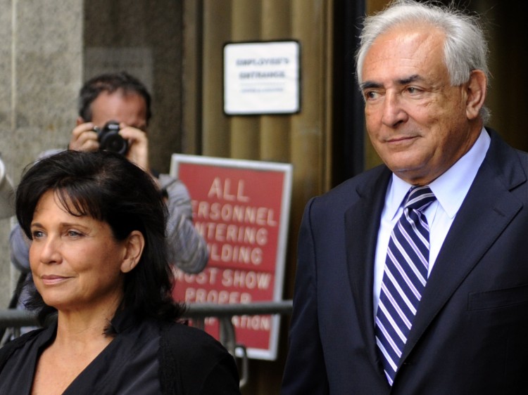 Former IMF head Dominique Strauss-Kahn and his wife Anne Sinclair leave Manhattan Supreme Court after his sexual assault charges were dismissed in New York Aug. 23, 2011.   (Timothy A. Clary/AFP/Getty Images)