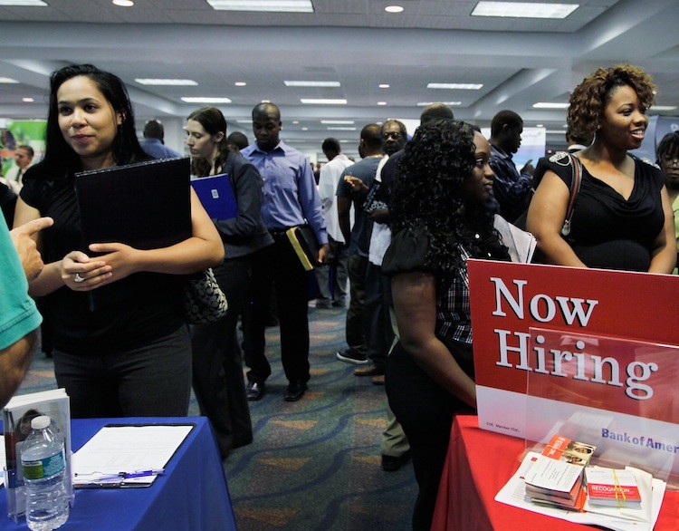 People looking for work at a recruiters desk setup at a job fair in the James L. Knight Center on August 23, in Miami, Florida.  (Joe Raedle/Getty Images)