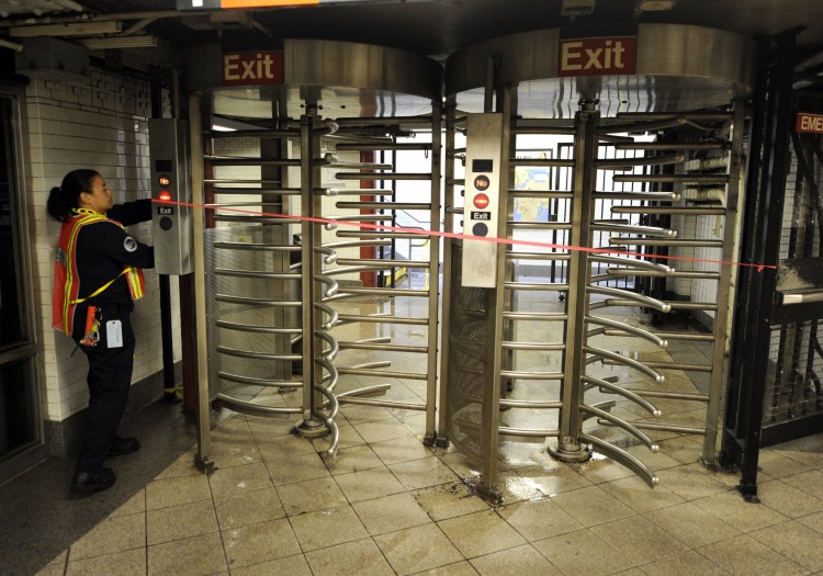 A MTA worker lockes up a gate at Union Square station