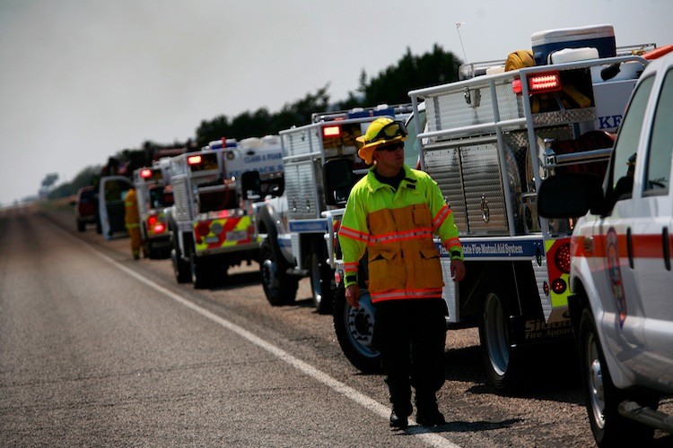 WILDFIRES: Firefighters stage along Highway 16 while fighting a wildfire on Sept. 1 in Graford, Texas. The Texas Forest Service (TFS) have responded to 63 new fires that have burned approximately 32,936 acres.   (Tom Pennington/Getty Images)