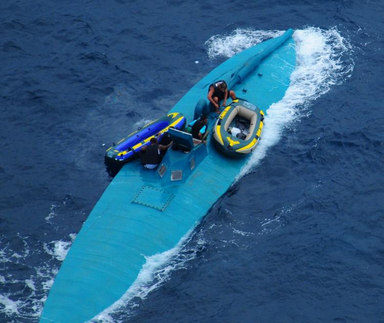 EASTERN PACIFIC DRUG BUST: The crew of a semi-submersible drug-trafficking vessel prepares to abandon ship before being intercepted by the U.S. Coast Guard northwest of the Colombian-Ecuador border on January 8. A dozen suspected drug smugglers were appre (U.S. Navy photo)