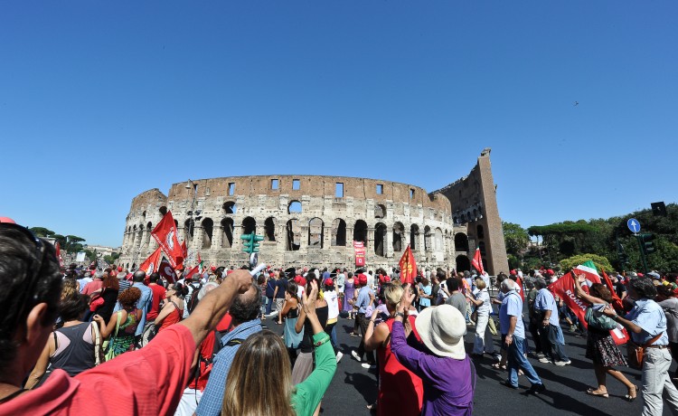 Workers march in front of the ancient Colosseum as they take part in a demonstration organized by CGIL against the government's economic austerity measures, in central Rome, on September 6. (Andreas Solar/AFP/Getty Images)