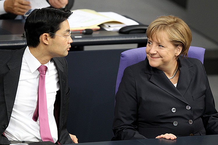 German Chancellor Angela Merkel talks with economy minister Philipp Roesler during a session at the Bundestag (Germany's lower house of parliament) in Berlin earlier this month. Yesterday, Bundestag voted to approve additional powers for Europe's bailout fund.(WOLFGANG KUMM/AFP/Getty Images)