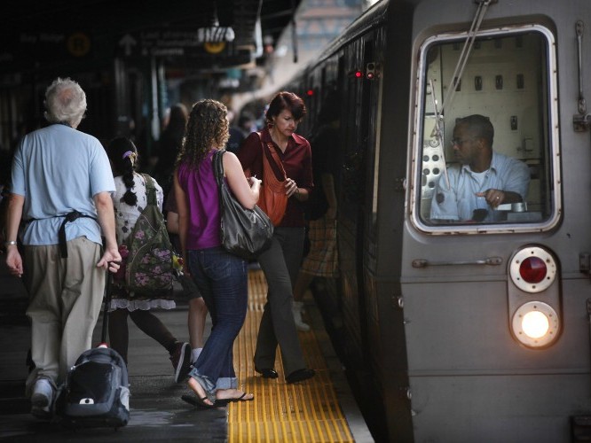 People ride the New York City subway into Manhattan