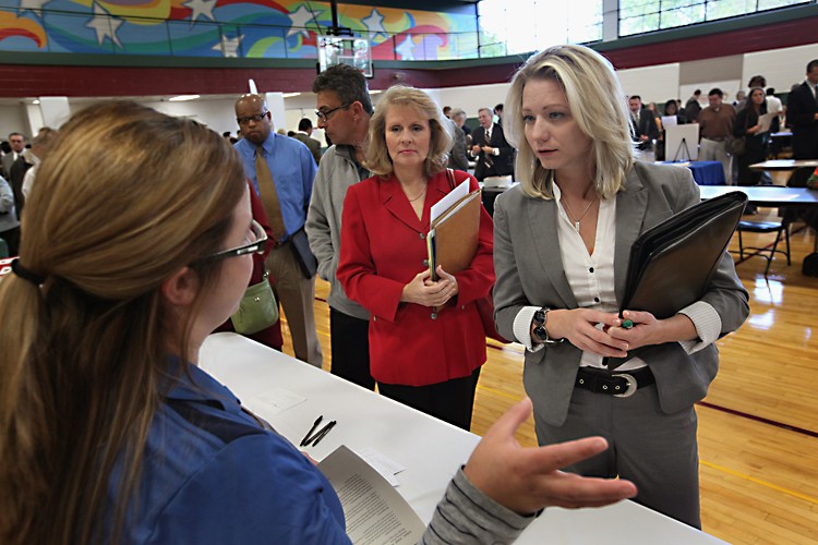 Jaclyn Weitzenfeld (R) speaks with a human resources representative from a casino during a job fair hosted by Illinois State Senator Dan Kotowski and the Illinois Department of Employment Security on Sept. 15 in Park Ridge, Illinois. (Scott Olson/Getty Images)
