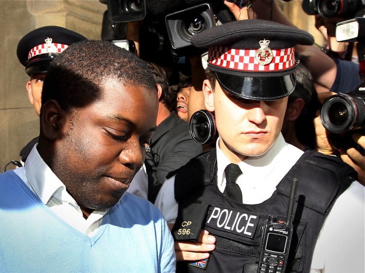UBS trader Kweku Adoboli (L) is led into a prison van as he leaves City of London Magistrates Court in London, on Sept. 16. Adoboli allegedly engaged in unauthorized trades, losing the bank in excess of $2.3 billion.  (Adrian Dennis/AFP/Getty Images)