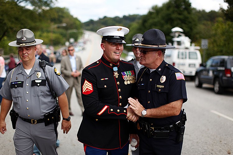 Former active duty Marine Corps Corporal and Medal of Honor recipient Dakota Meyer (C) walks with Kentucky law enforcement officers. (Luke Sharrett/Getty Images)