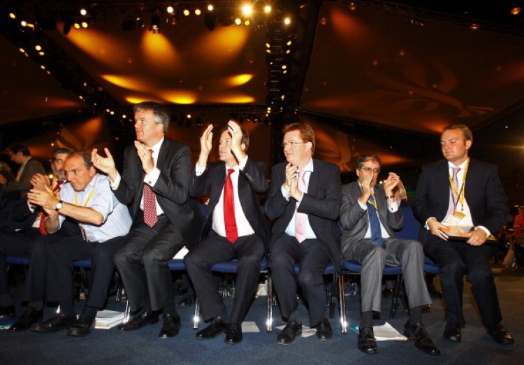 Lib Dem leader Nick Clegg gets to his feet to applaud a speech by Secretary of State for Energy and Climate Change Chris Huhne at the Lib Dem Autumn Conference. (Matt Cardy/Getty Images )