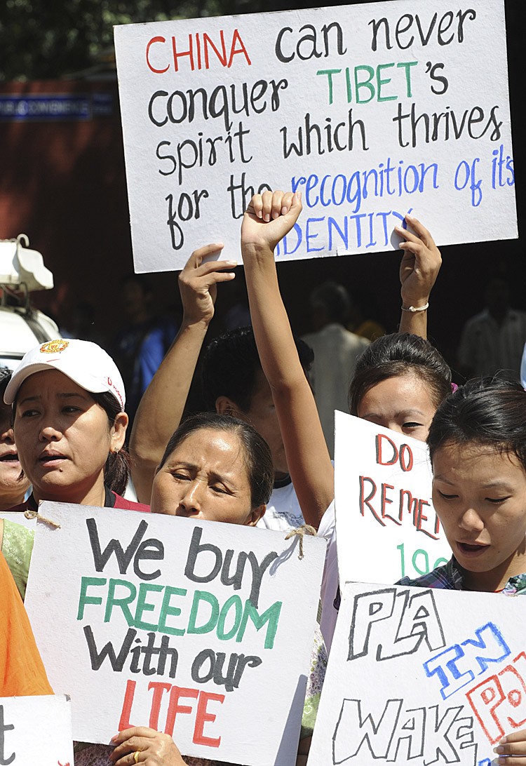 Tibetans in-exile hold placards during a protest march in New Delhi on Sept. 30, following the self-immolation of two monks inside Tibet on Sept. 26, in an apparent call for religious freedom. (Raveendran/AFP/Getty Images)