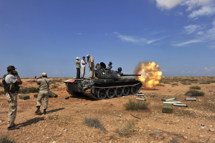 A National Transitional Council tank fires shells against troops loyal to Moammar Gadhafi in the town of Sirte on October 4, 2011. (Aris Messinis/AFP/Getty Images)