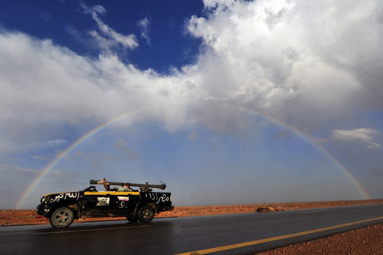 A National Transitional Council soldier drives his vehicle on the highway between Mistrata and the battle front town of Sirte on October 4, 2011. (Aris Messinis/AFP/Getty Images)