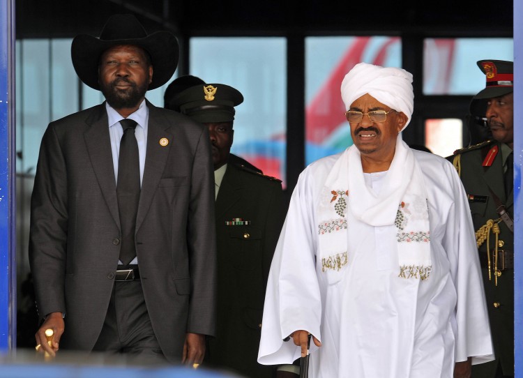  Sudanese President Omar Hassan Ahmad al-Bashir (R) greets his South Sudanese counterpart President Salva Kiir Mayardit on Oct. 8, 2011, upon the latter's arrival in Khartoum for his first visit after South Sudan's secession from Sudan. The two nations made nine agreements, but still have not implemented them and the conflict between the two, particularly centered on oil resources, could escalate. (EBRAHIM HAMID/AFP/Getty Images)