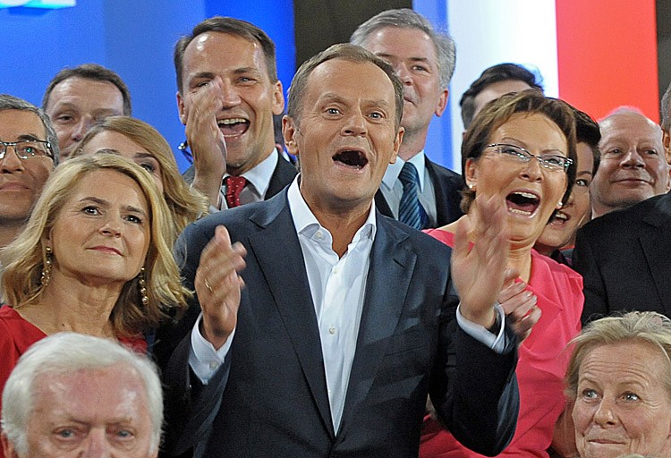 Polish Prime Minister Donald Tusk (C), leader of Civic Platform and his wife Malgorzata (L) with his supporters react after the announcement of the exit polls results of the the parliamentary elections on October 9, in Warsaw. Polish citizens today will elect a new parliament, deciding mainly between the ruling Civic Platform party and the oppositional Law and Justice party. (JANEK SKARZYNSKI/AFP/Getty Images)