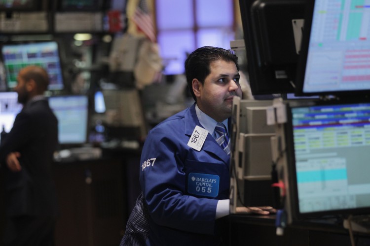 A trader works on the floor of the New York Stock Exchange, Oct. 10. A hacker group, Anonymous, reportedly targeted the NYSE.com website in the afternoon, but trading was not affected. (Spencer Platt/Getty Images)