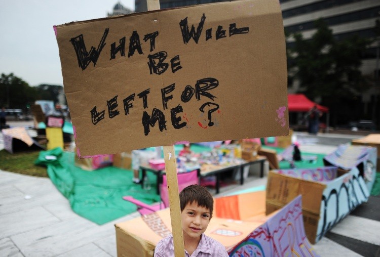 A young participant displays a placard during anti-corporations demonstration at the Freedom Plaza in Washington, D.C., on October 11, 2011. (Jewel Samad/AFP/Getty Images)