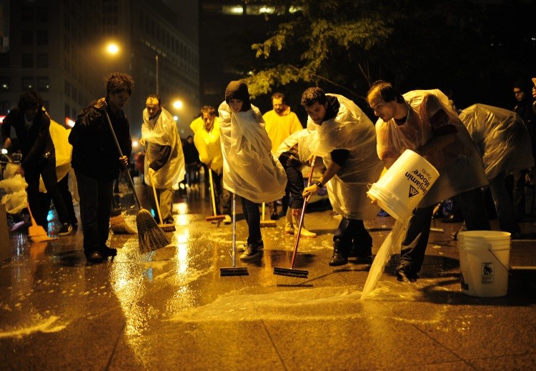Members of Occupy Wall Street clean Zuccotti Park near Wall Street in New York on October 13, 2011. (Emmanuel Dunad/AFP/Getty Images)