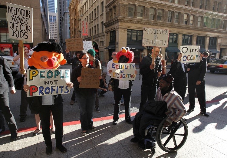 Occupy Wall Street protestors stage a demonstration outside of the National Summit on Education Reform where News Corp. CEO Rupert Murdoch was delivering a keynote address on October 14, 2011 in San Francisco, California. (Justin Sullivan/Getty Images)