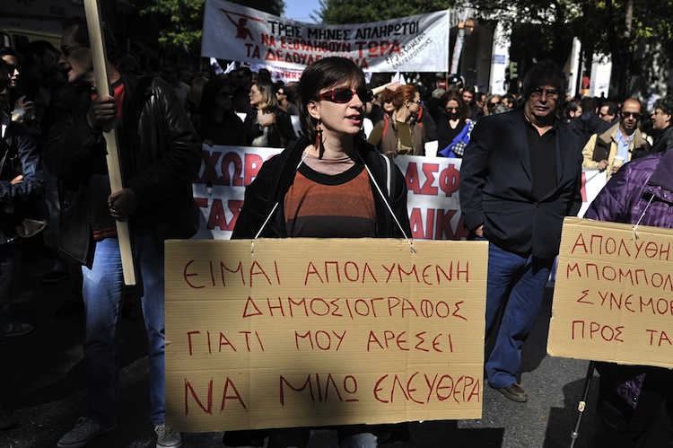 A Greek journalist carries a placard during a 24-hour strike on Oct. 18, 2011 in Athens. Greek journalists will go on strike Nov. 6 to Nov. 7 following the suspension of three journalists on Tuesday. (LOUISA GOULIAMAKI/AFP/Getty Images) 