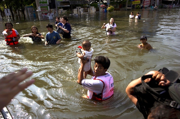 A Thai rescuer holds up a baby in the floodwaters in Bang Bua Thong, in Nonthaburi province, on the outskirts of Bangkok, on October 19. (Nicolas Asfouri/Getty Images )