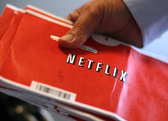 A U.S. Postal worker holds a stack of Netflix envelopes at a Post Office sort facility on October 24, 2011 in San Francisco, California.  (Justin Sullivan/Getty Images)