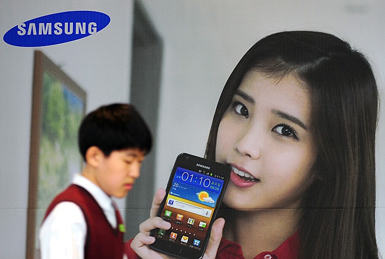 A South Korean high school student walks past advertising for the Samsung Electronics mobile phone Galaxy S II LTE in Seoul, Oct. 28. South Korea's Samsung Electronics overtook key rival Apple in the lucrative smartphone market. (PARK JI-HWAN/AFP/Getty Images)