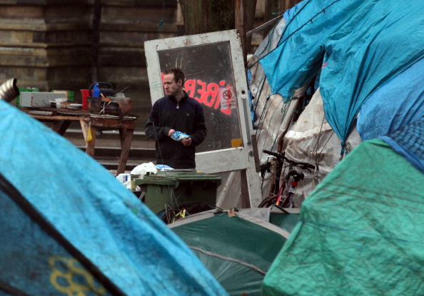 A lone protester looks out from a structure in the remains of the Occupy Bristol camp on College Green on January 24, 2012 in Bristol, England. The remaining anti-capitalist demonstrators still at the camp - which became the largest tented demonstration outside London and was set up in solidarity with the international Occupy movement - have been served with an eviction notice and have been told they will be forcibly removed if they do not leave of their own accord. (Photo by Matt Cardy/Getty Images)