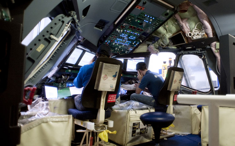 Employees are at work in the cockpit of an A380 plane