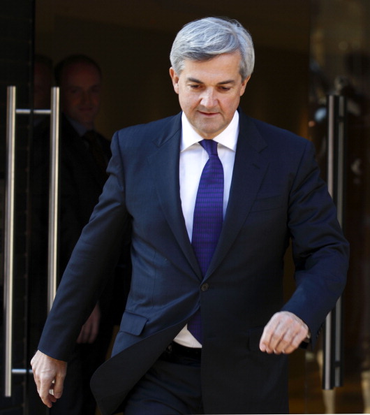 British Energy and Climate Change Secretary Chris Huhne walks out of the door of his London flat on February 3, 2012 to give a statement to the media resigning as energy and climate secretary over speeding charges. In a brief statement to the press Huhne resigned his position in the Cabinet and reaffirmed his innocence after the Crown Prosecution Service (CPS) announced that they would be bringing charges against Huhne over allegations he dodged a speeding penalty. AFP PHOTO / JUSTIN TALLIS (Photo credit should read JUSTIN TALLIS/AFP/Getty Images) 
