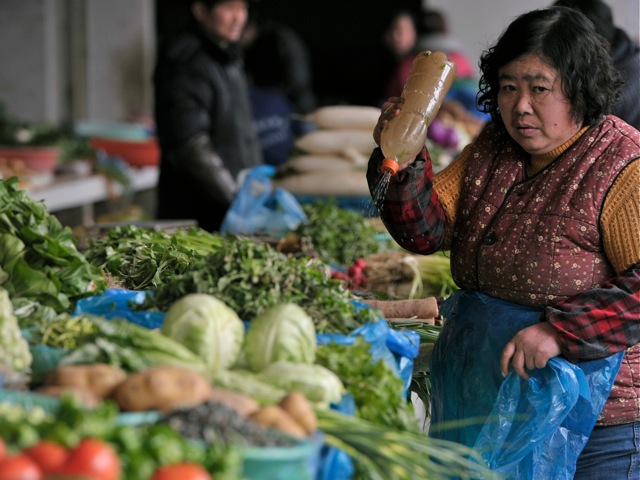 Venders sell vegetables in a market