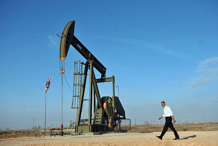 US President Barack Obama walks past an oil rig