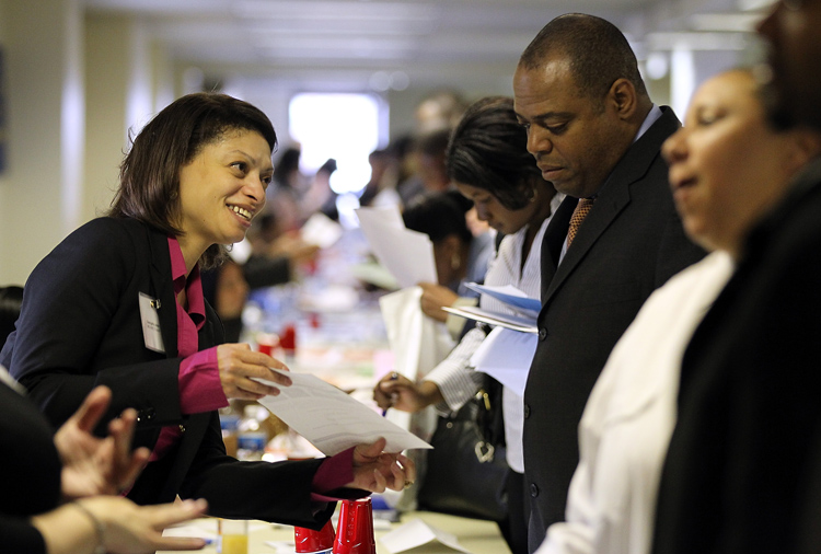 A job seeker meets with a recruiter during a job fair in Brooklyn