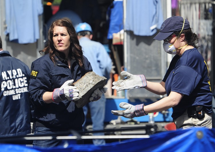 New York police and FBI agents remove pieces of concrete