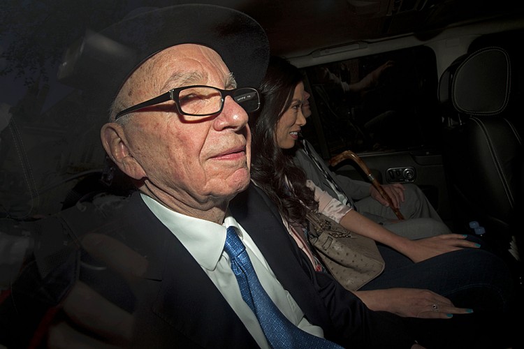 Rupert Murdoch (L) and family are driven away from the High Court in Central London on April 26 after Murdoch's second and final day of giving evidence at the Leveson Inquiry into an alleged cover-up of phone hacking at the now-defunct News of the World tabloid newspaper. (JUSTIN TALLIS/AFP/GETTY IMAGES)